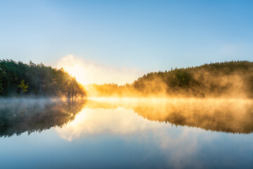 Sunrsise at the lake with morning fog - obrazy, fototapety, plakaty