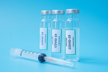 COVID-19 Vaccine vial and injection Needle Syringe against Coronavirus infection in hospital laboratory. Medical, health, Vaccination and immunization concept