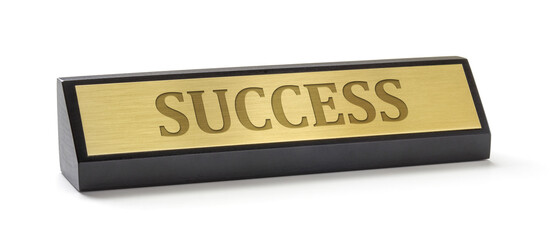 A name plate on a white background with the engraving Success