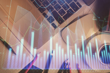 Double exposure of financial chart drawing over table background with computer. Concept of research and analysis. Top view.