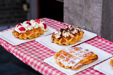 Naklejka premium Traditional belgian waffles with fresh fruit and whipped cream