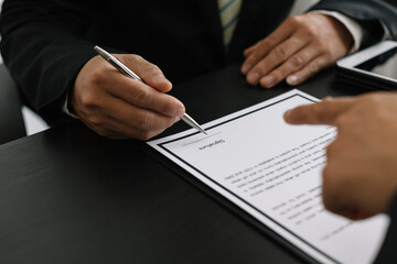 Hands of businessmen agreeing to the offer of bribery by signing a personal benefit agreement The concept of fraud and business practices within the company