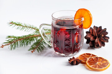 Glass cup with mulled wine on white background. Winter warming drink.