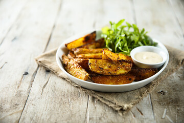 Roasted potato wedges with salad and dip