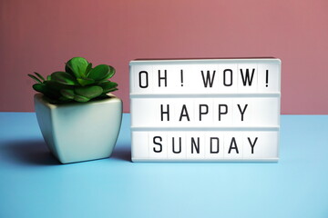 Happy Sunday word in light box on blue and pink background
