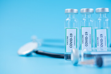 COVID-19 Vaccine vial, injection Needle Syringe and Stethoscope against Coronavirus infection in hospital laboratory. Medical, health, Vaccination and immunization concept