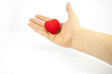 Red heart in a hand on white background