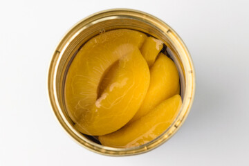 Canned peaches on a white background