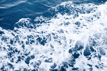Aerial view to ocean waves. Blue water background