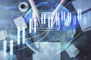 Multi exposure of woman hands working on computer and forex chart hologram drawing. Top View....
