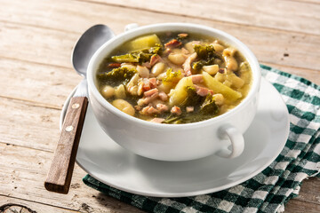 Creamy Tuscan soup in bowl on wooden table