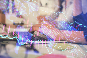 Multi exposure of woman hands typing on computer and financial graph hologram drawing. Stock market analysis concept.