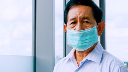 Senior man wearing protective face masks during quarantine at home.