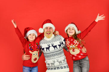 happiness. bearded santa man with kids. knitted fashion for everyone. warm and cosy winter. new year is coming. happy family celebrate xmas. small girls love their father. dad embrace daughters
