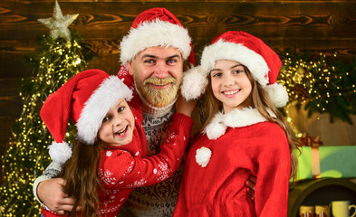 Fototapeta na wymiar Lovely family at home. Spread love around. Father and little daughters celebrate new year. Christmas becomes special with children. Christmas eve concept. Christmas spirit. Dad kids having fun