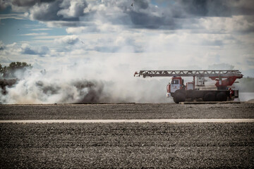 Fototapeta premium Russian fire truck in the smoke from the fire