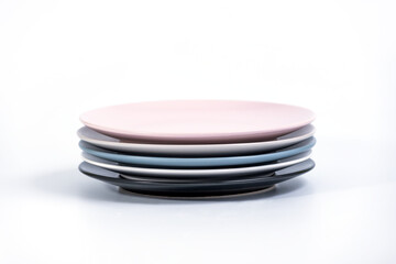 Stack of five colorful empty plates isolated on white background, side view. Black, White, Navy Blue, Grey 

and Pink empty plates collection