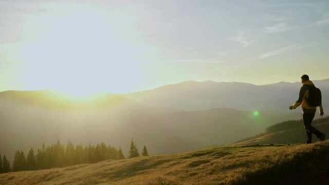 A man travels in the mountains. Beautiful nature of the Carpathian mountains. The concept of travel and active lifestyle. 4K