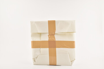 Obraz premium Taped packet isolated on white background, secure parcel