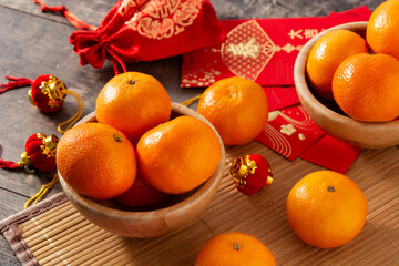Chinese new year festival decorations and oranges on wooden table. 	