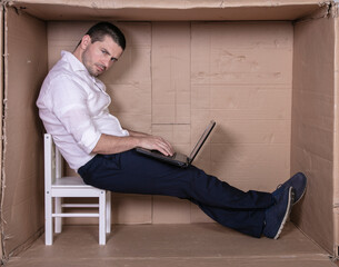 broken businessman in a cardboard office, stress and depression from overwork