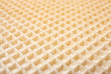 Empty wafer texture as background. Closeup view of golden waffle