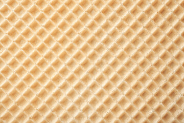 Empty wafer texture as background. Closeup view of golden waffle. Top view