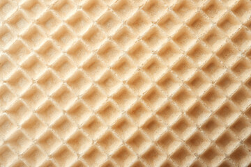 Empty wafer texture as background. Closeup view of golden waffle. Top view
