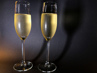 Cold champagne in two stylish glasses, bubbles, in sparkling wine, concept of new year,...