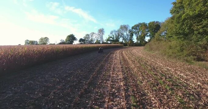 Quad Bike Driving on a Field on a Sunny Autumn Afternoon in Borrby &Ouml;sterlen in South Sweden Sk&aring;ne, Aerial Low Altitude