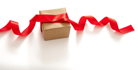 Gift box and red satin ribbon on white background, top view. Valentine, christmas present