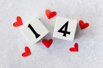 14 February. White wood calendar with red hearts on top Valentine's Day card mockup. Flat lay.