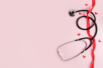 Stethoscope medical equipment with red hearts on pink background. health care with love. valentine's day