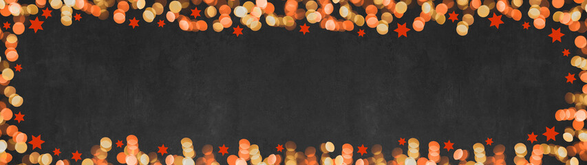 Christmas advent background banner panorama template - Top view of frame made of red orange yellow bokeh lights and stars isolated on black texture, with space for text