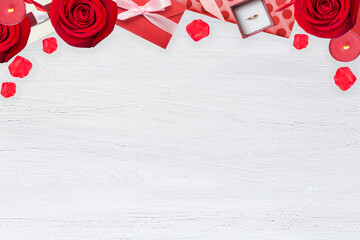 Valentines background with red rose, valentine envelope, ring on the wooden table, flat lay with copy space, top border