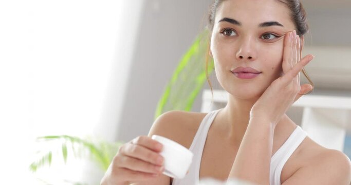 woman applying makeup on her face