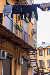 Between the old houses in the historical center of Lviv, at a high altitude, there are stretched ropes on which linen and clothes dry. Streets of the old city.