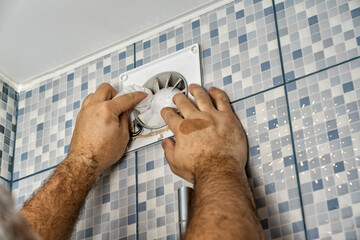 master cleans a very dirty exhaust fan in the bathroom