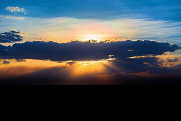 Awesome sunset with sunbeams in the evening sky