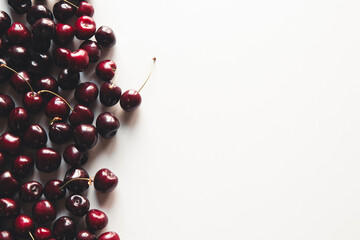 Fresh ripe cherry on the white wooden background. Top view, copy space