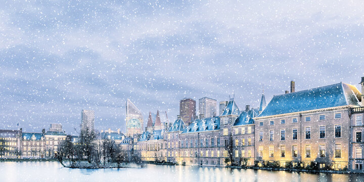 Winter view of The Hague city center with the historic parliament buildings during snowfall
