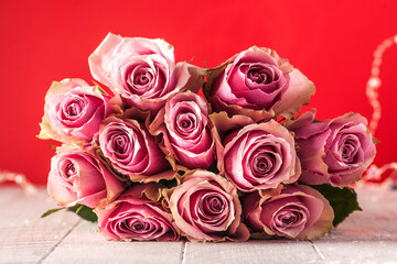 Valentine's day background. Bouquet of roses on a red background. Concept February 14, March 8