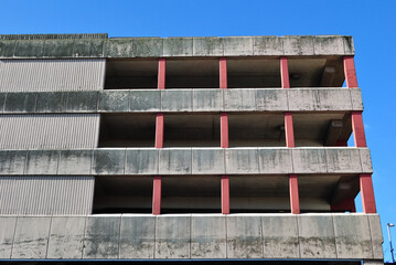 Close Up of Facade on Modern Concrete  Multi Story Car Park seen against Blue Sky