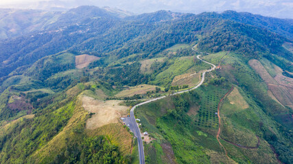 Fototapeta na wymiar aerial view mountain paths rural road between the city