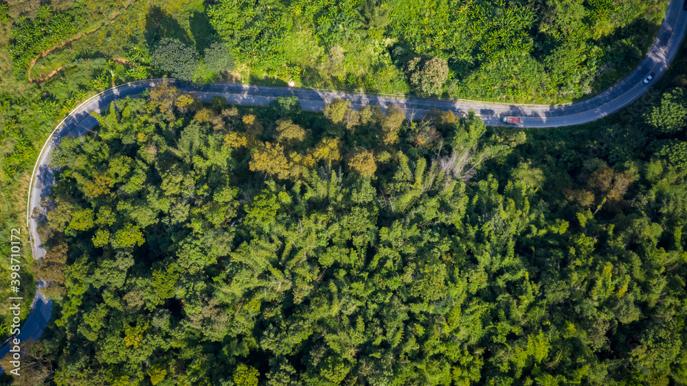 Wall mural aerial view mountain paths rural road between the city