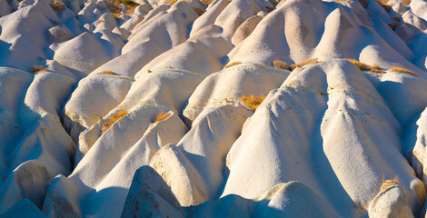 Fototapeta na wymiar Panoramic sand hills under sun in Cappadocia, Turkey