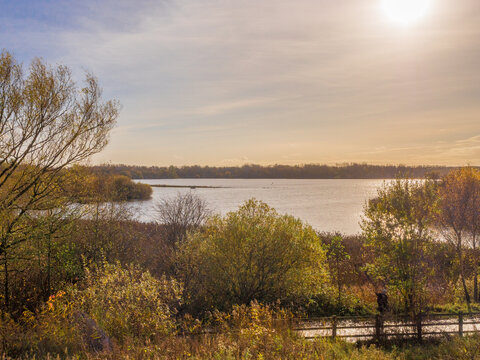 Autumn trees over water at Pennington Flash, Leigh, Warrington, UK