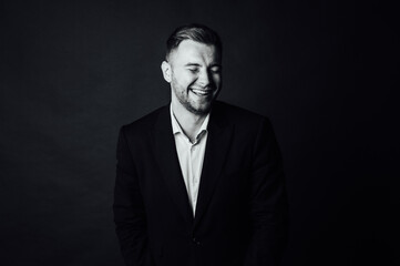 Handsome male businessman with suit posing in a photo studio. Half-length portrait