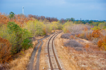 Fototapeta na wymiar Single track railway in the autumn forest.