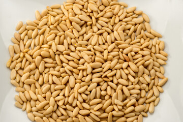 pine nuts, heap of seeds isolated on white background in top view